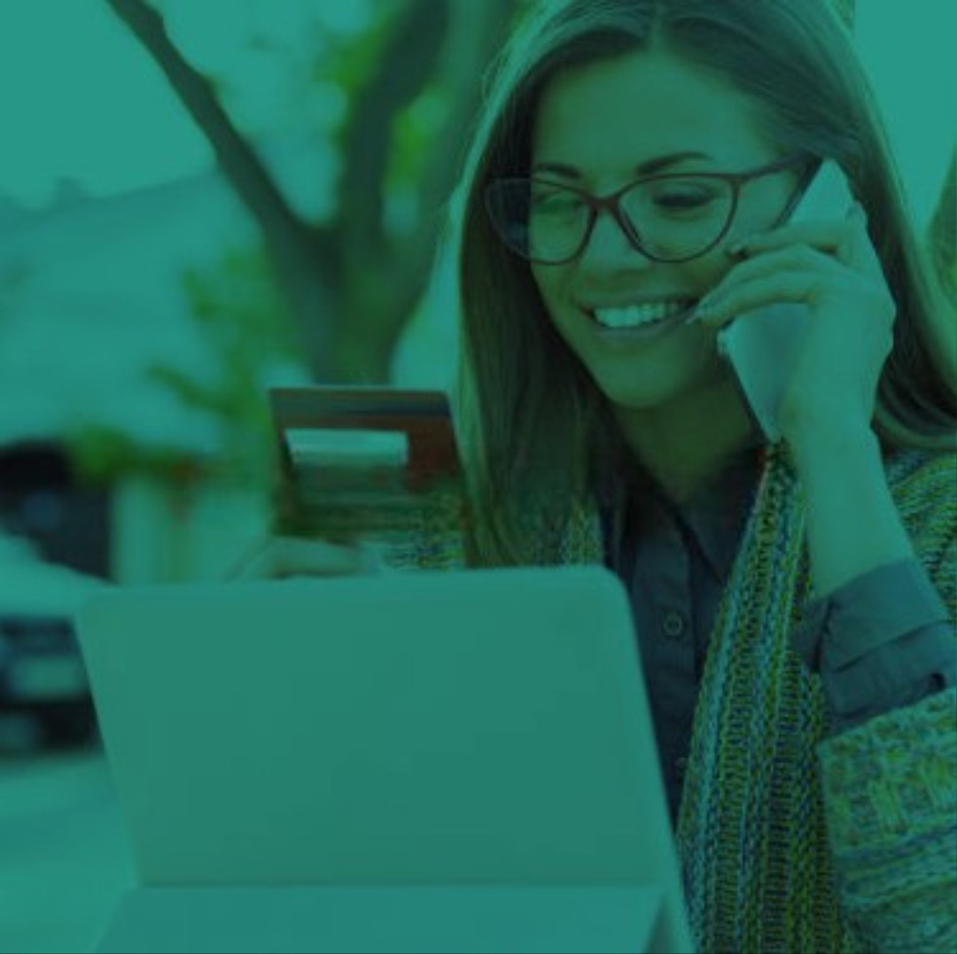 Perth Family Law: Woman manages consent orders, using her laptop and phone. Clairs Keeley Lawyers can assist with consent orders in Perth.