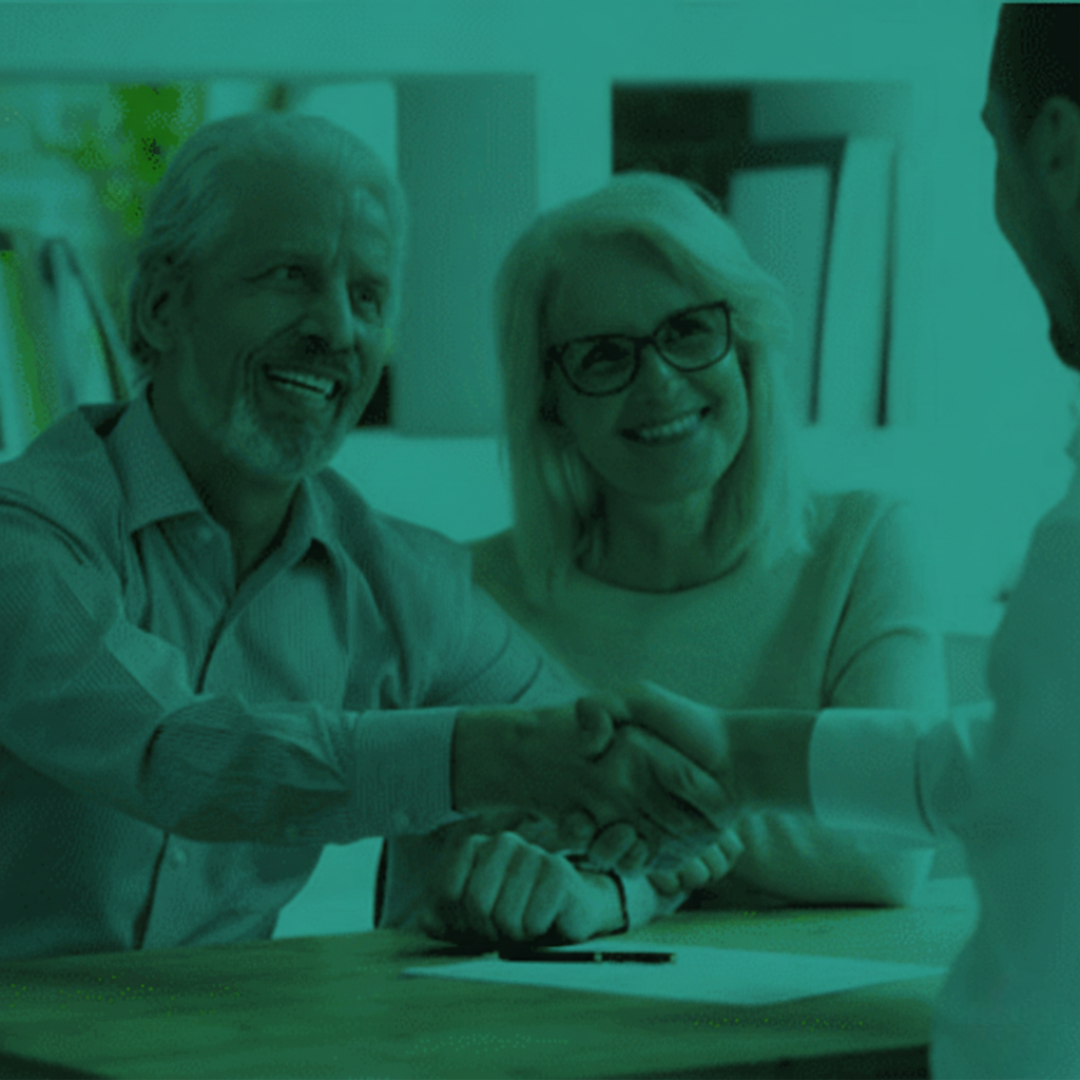 Perth lawyers Clairs Keeley assist with Wills and Estate Planning. Senior couple shake hands with lawyer, signifying agreement on estate administration.