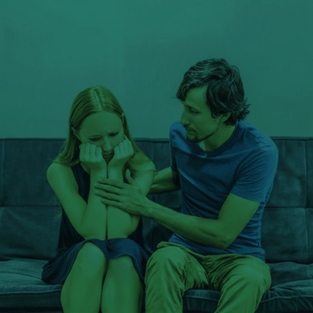Family Dispute Resolution: Concerned man comforting a distraught woman. Seek Family Law legal support in Perth from Clairs Keeley Lawyers.