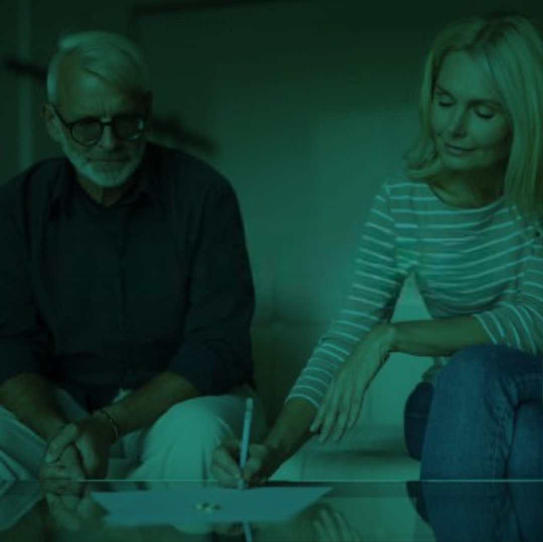 Perth Family Law: Couple signing financial settlement agreement. Clairs Keeley Lawyers assist with property and financial matters in divorce.