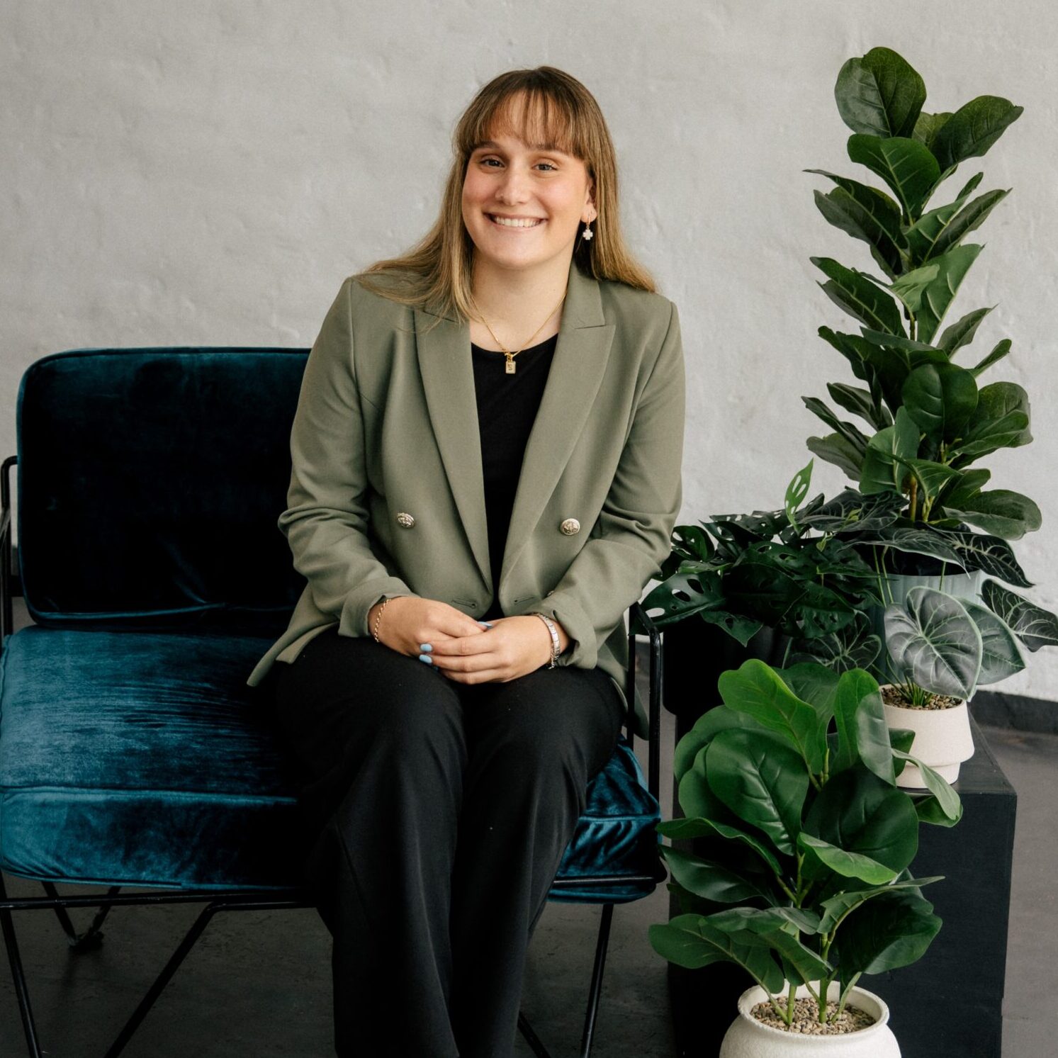Clairs Keeley Lawyers Support Staff: Smiling woman in blazer, indoor plants, furniture. Perth legal team for Family & Commercial Law, Estates.