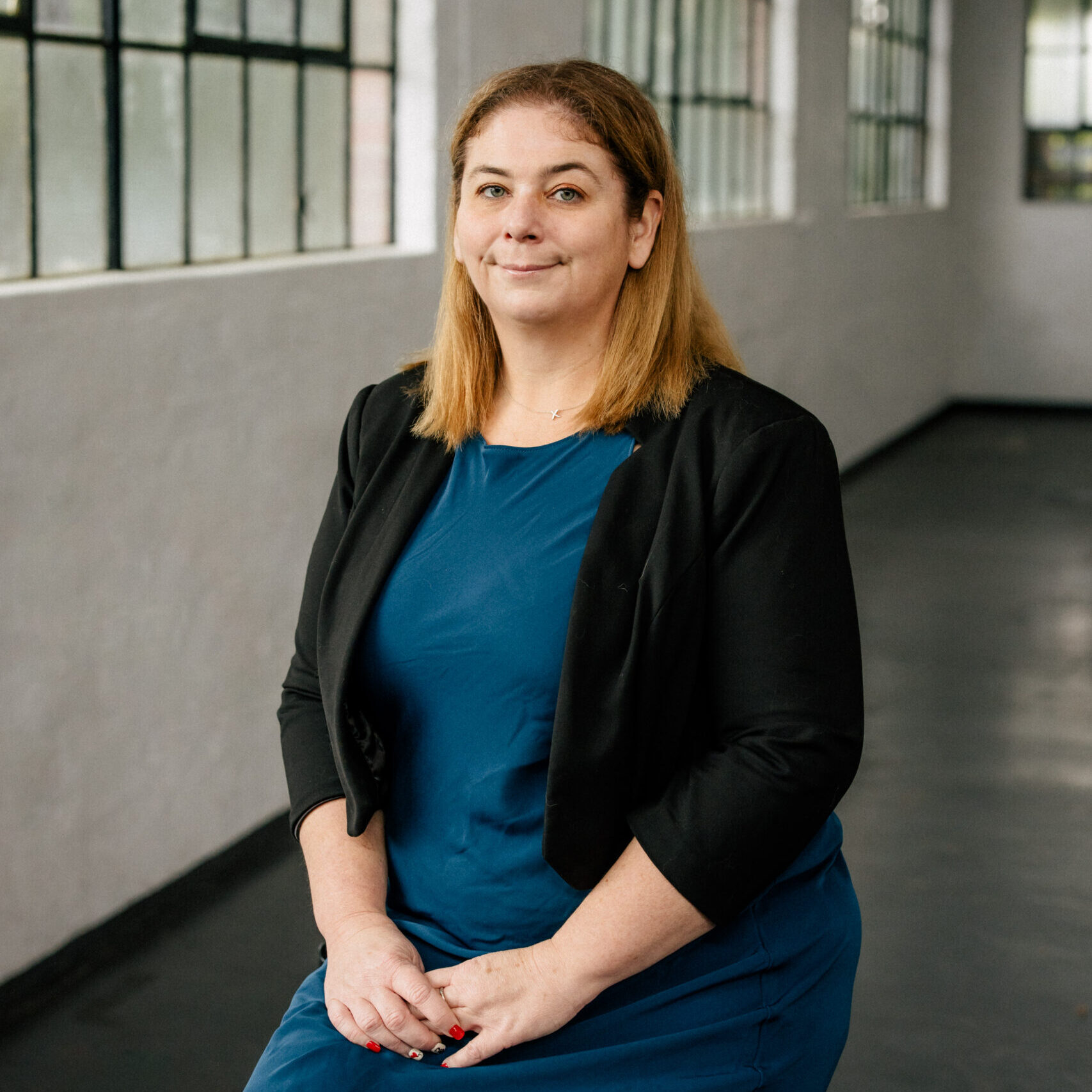 Perth Lawyer Support Staff Portrait: Professional woman in blue dress, Clairs Keeley Lawyers, East Perth. Family & Commercial Law Services.