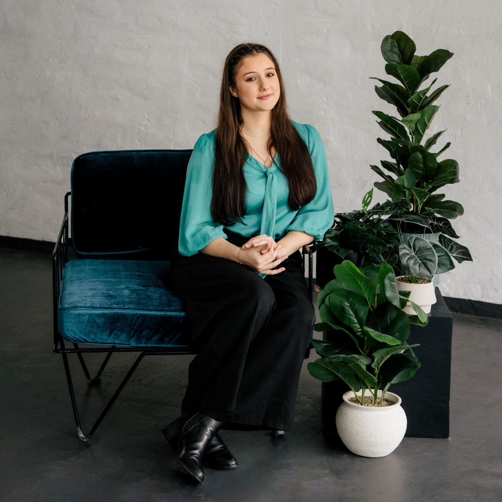 Perth Lawyers Support Staff: Woman sits on velvet chair with indoor plants. Clairs Keeley, East Perth, offers Family & Commercial Law services.