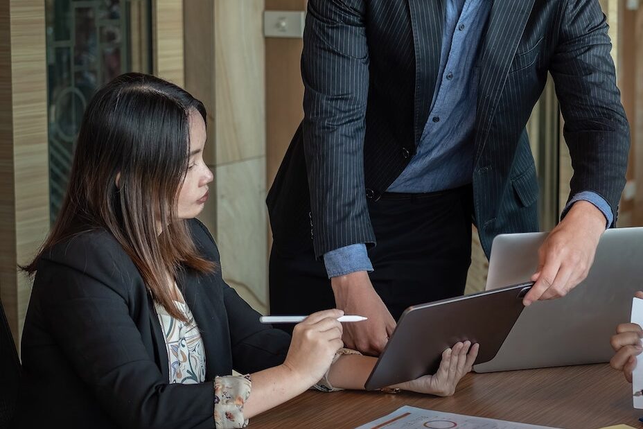 Perth Commercial Law meeting showing diversity, tablet, laptop use. Clairs Keeley Lawyers assist with commercial and business legal advice.