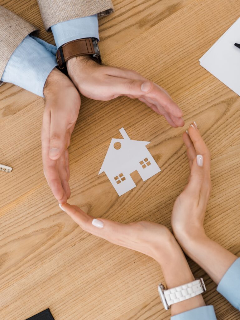 Estate Planning Perth: Couple protects a house with hands. Wills & Estate Lawyers at Clairs Keeley Lawyers offer peace of mind for your estate.