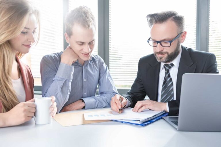 Perth Lawyers reviewing de facto relationship contract. Couple meeting with advisor to sign finance document at Clairs Keeley Lawyers in Perth.