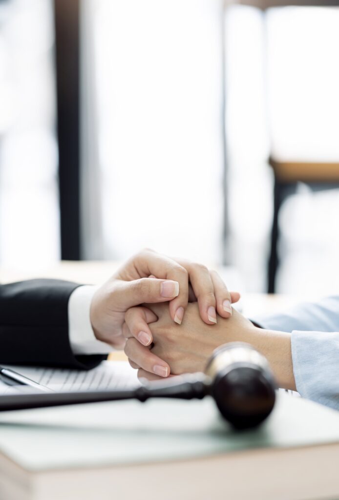 Hands clasped in support with gavel for Deceased Estates, Probate, and Letters of Administration in Perth by Clairs Keeley Lawyers, East Perth.