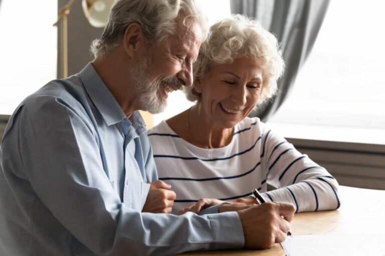 Elderly couple signing Enduring Power of Attorney document in Perth. Clairs Keeley Lawyers assist with estate planning, wills, estates, probate.