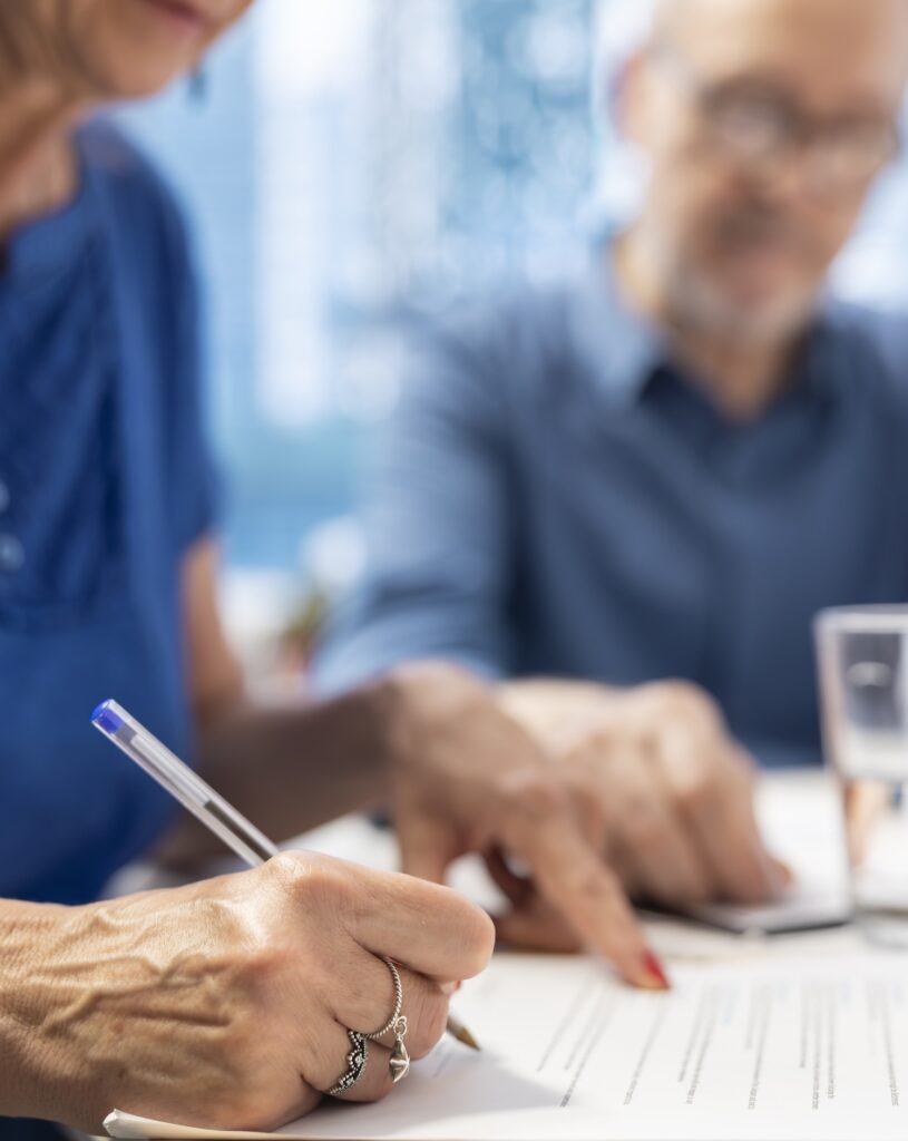 Mature person signing financial contract for Complex Wills, Estates, Probate, Perth from Clairs Keeley Lawyers family & commercial law