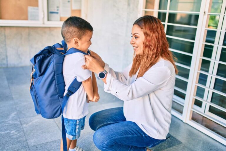Affectionate mother adjusting son's backpack before school in Perth. Family domestic violence support by Clairs Keeley Lawyers, offering legal aid.