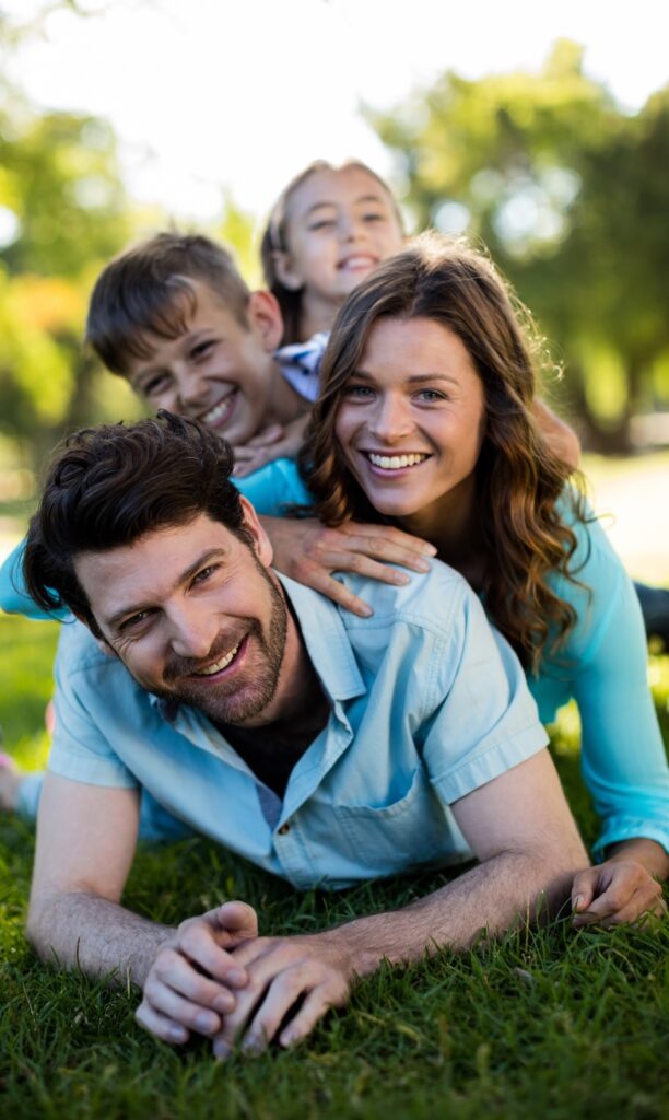 Happy Perth family playing in park, smiling. Clairs Keeley Lawyers assist with Wills, Estate Planning, and Simple Wills for Perth families.