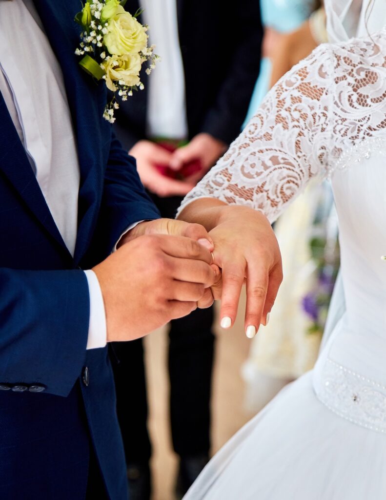 Perth Family Law: Bride and groom exchange rings at wedding. Clairs Keeley Lawyers offer estate planning, simple wills, & probate services.