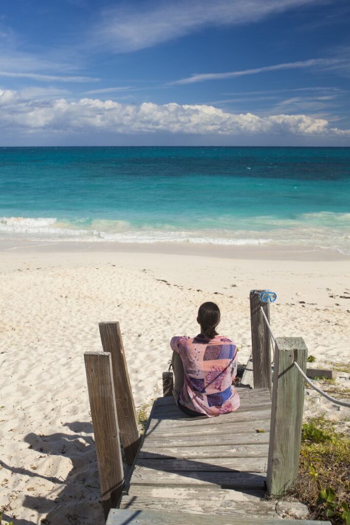 Woman looking over tropical beach, Perth. Clairs Keeley Lawyers specialize in Will Disputes, Estate Planning, and Probate in East Perth.