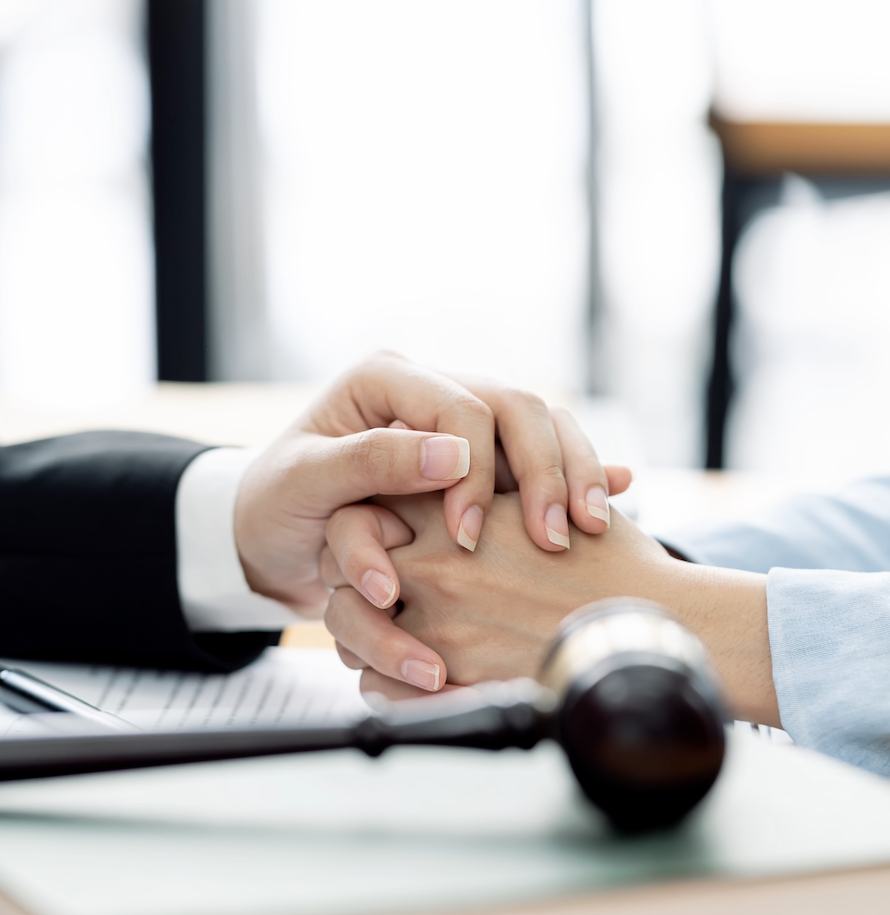 Deceased Estates Lawyers Perth: Hands clasped with gavel, representing Clairs Keeley Lawyers' estate planning services.